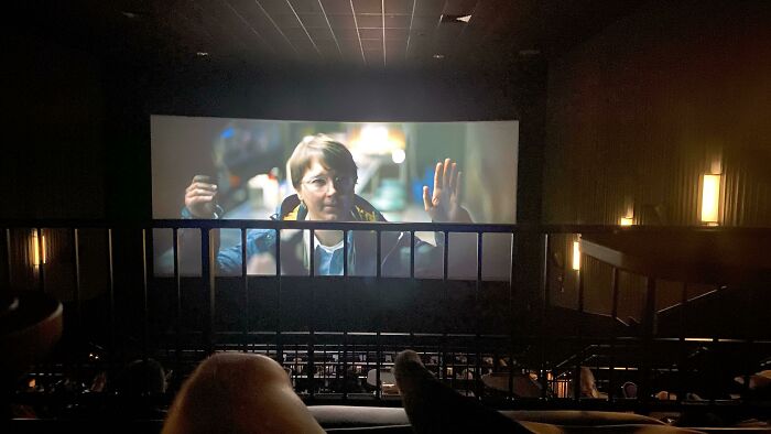 View of an unfortunate public interior design in a movie theater with obstructed screen visibility.