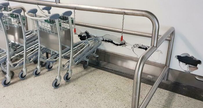 Trolleys misaligned with wall barrier causing damage, illustrating unfortunate interior designs.