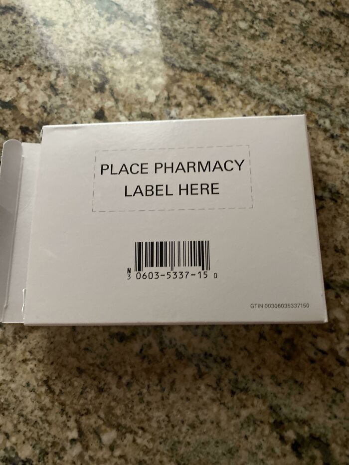 Medication box on a counter labeled "PLACE PHARMACY LABEL HERE," highlighting local pharmacies' frustrations.