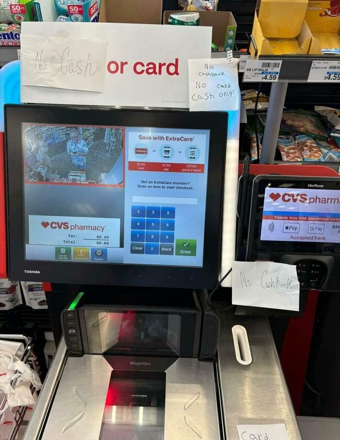 Infuriating local pharmacy checkout shows conflicting signs about payment methods, causing customer confusion.