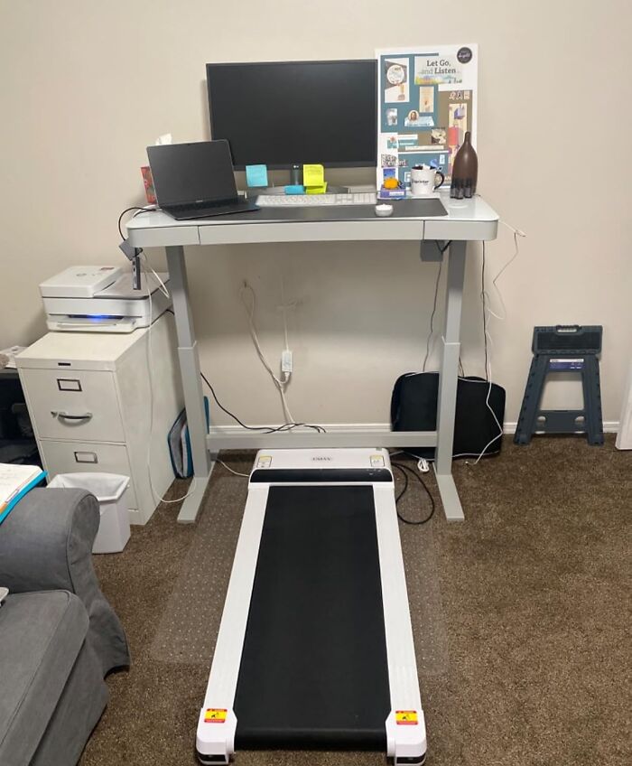 Standing desk setup with laptop, monitor, and treadmill for a more put-together work environment in 2025.