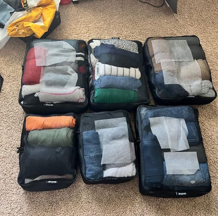 Organized packing cubes with neatly folded clothes to feel more put together.