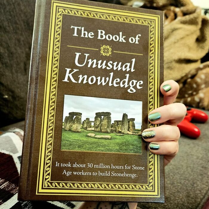 Person holding "The Book of Unusual Knowledge" with colorful nails, suggesting ways to feel more put together.