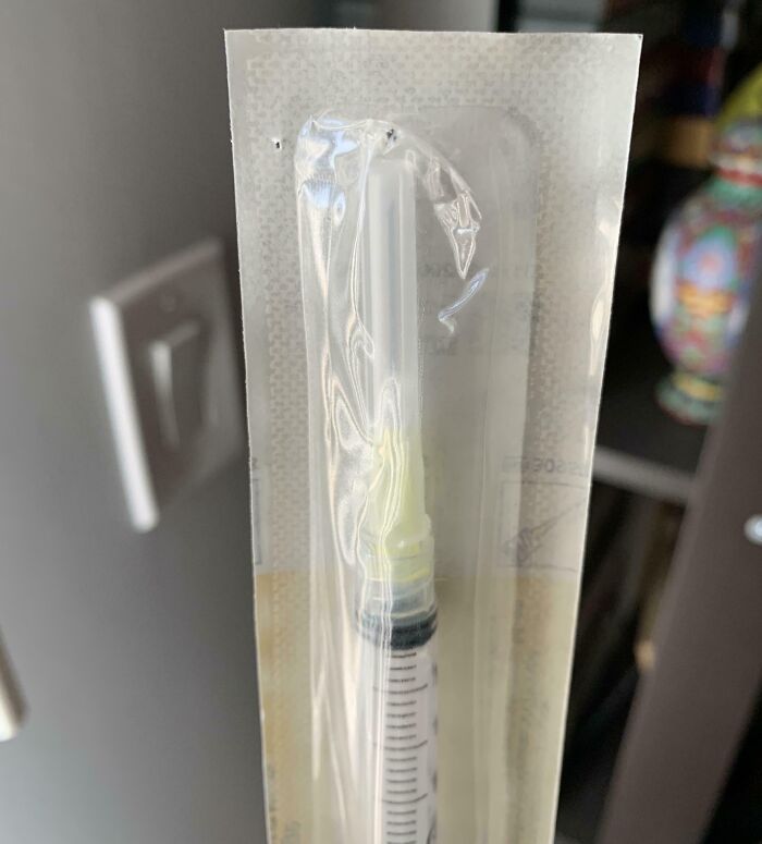 Sealed medical syringe with a bent needle, highlighting local pharmacy issues.