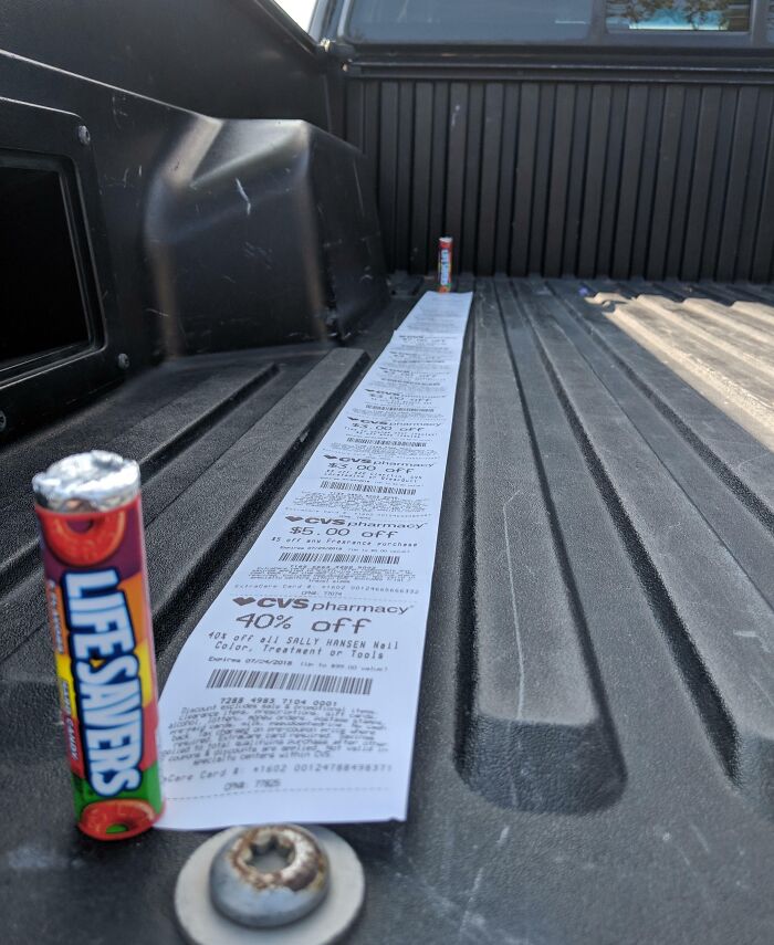 Long pharmacy receipt in a truck bed next to a Lifesavers candy roll, symbolizing infuriating local pharmacies.