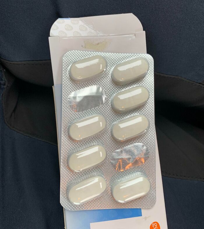 Blister pack of pills from local pharmacies with one empty slot, highlighting frustration with packaging.