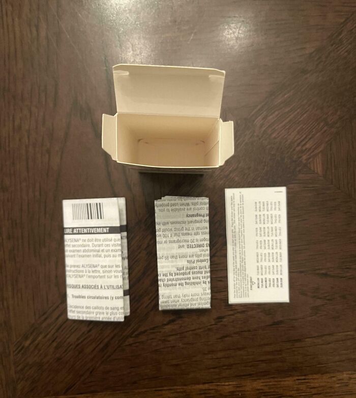 Empty medicine box and leaflets on a wooden table, illustrating the challenges with local pharmacies.