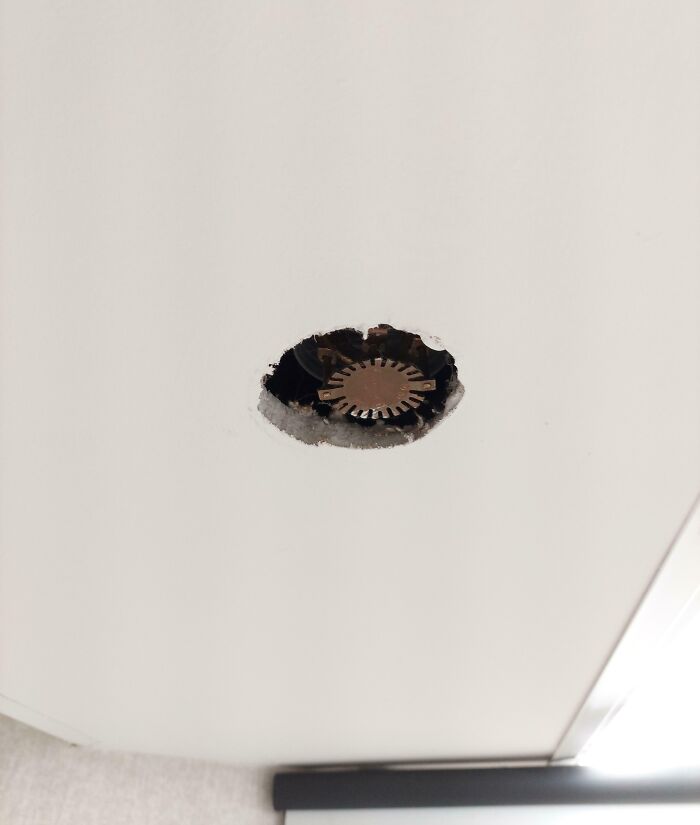 Damaged ceiling with exposed sprinkler cap in a local pharmacy.