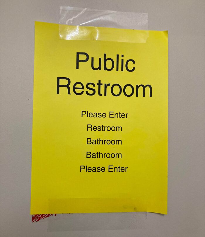 Yellow restroom sign with repetitive text, highlighting confusion often found in local pharmacies.