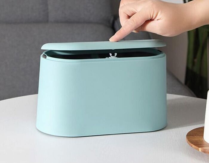 Hand opening a sleek blue container, ideal for elegant upgrades in a remote work setup.