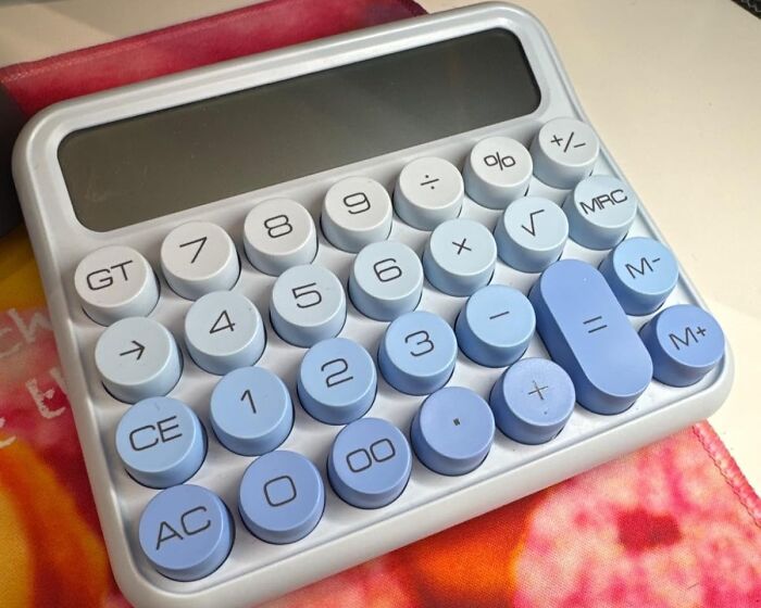 A stylish calculator with round digit buttons, essential for remote workers seeking elegant upgrades.