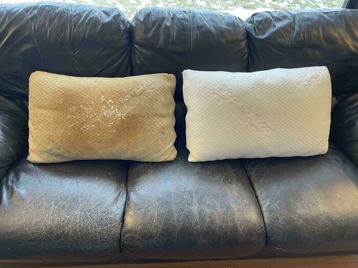 Worn-down pillow next to a new pillow on a leather couch, illustrating how time affects objects.