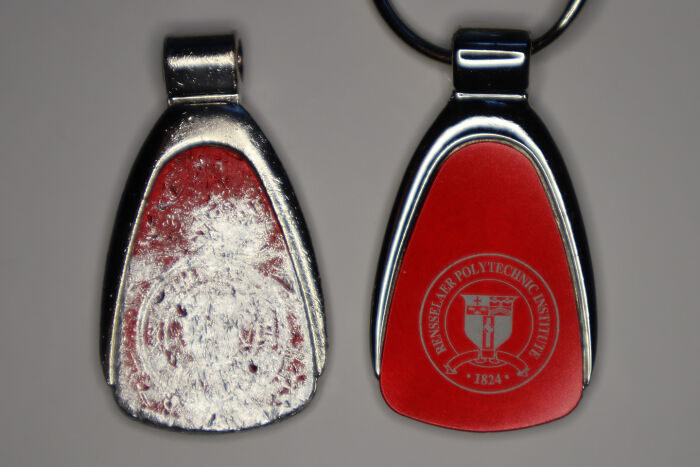 Worn-down red keychain next to a new one illustrating the passage of time.