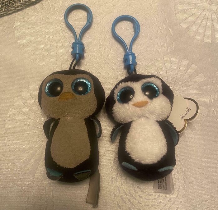 Two plush penguin keychains show signs of wear, illustrating the passage of time.