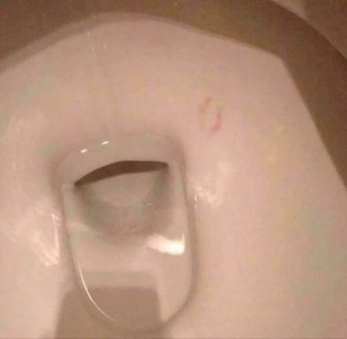 A toilet with lipstick marks inside, highlighting a prank or people being complete jerks.