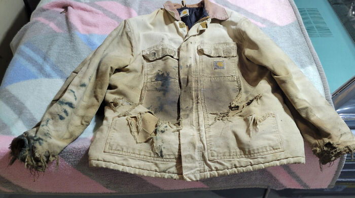 Worn-down jacket illustrating effects of time with frayed edges and faded fabric.