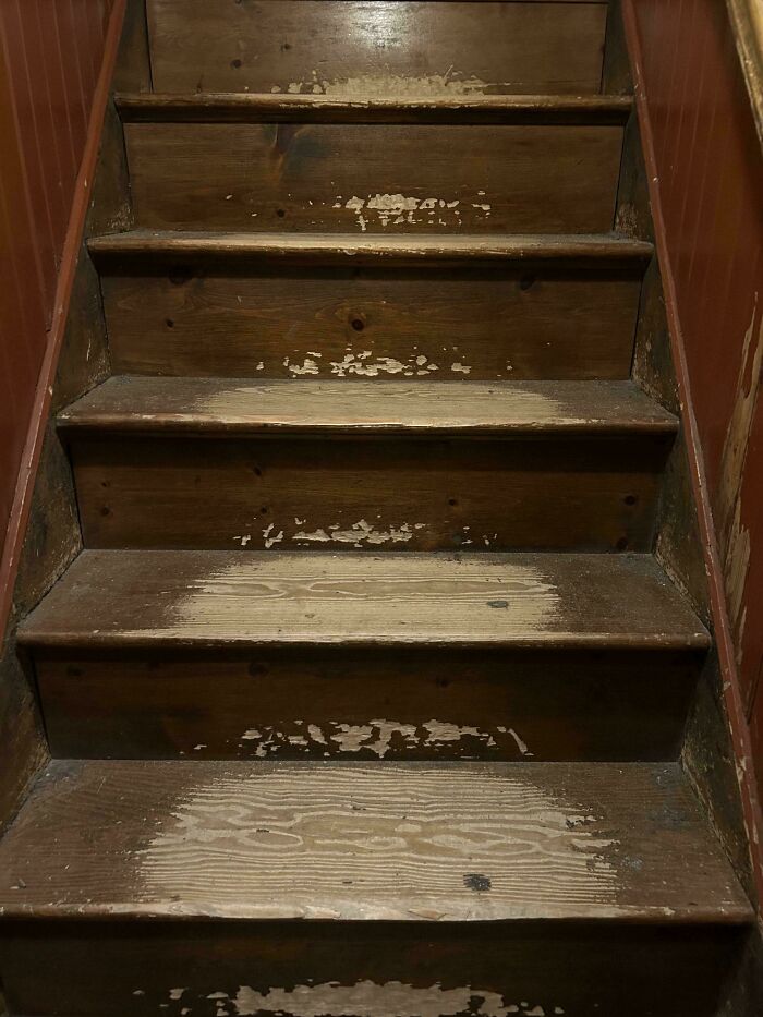 Worn-down wooden stairs showing the effects of time and usage.