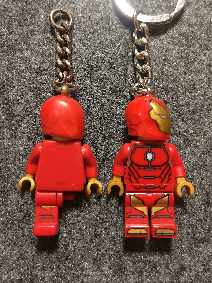 Two worn-down Iron Man keychains showing signs of wear over time.