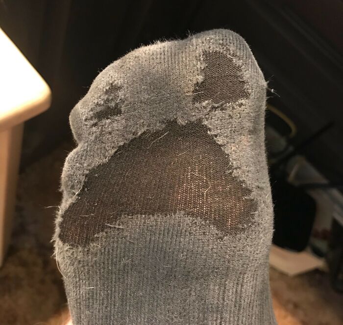 Worn-down sock with several large holes illustrating how time works.