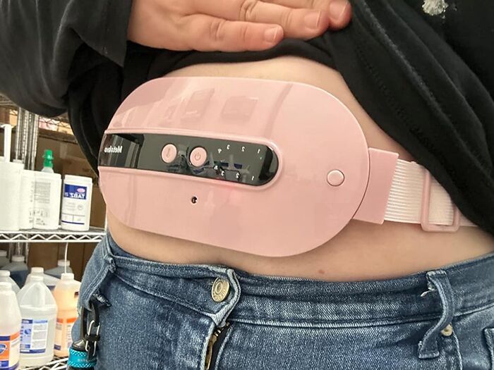 Person wearing a pink abdominal heating pad, one of the hottest new Amazon releases.