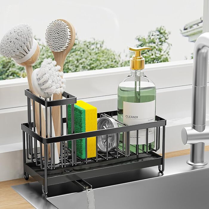 Modern kitchen sink organizer with brushes, sponges, and a bottle of cleaner, one of the hottest new Amazon releases.