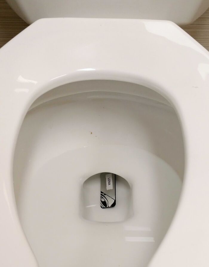 Toilet with a business card in the bowl, symbolizing people quitting jobs.