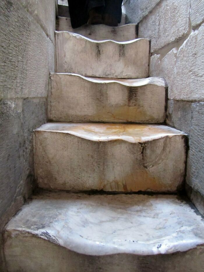 Worn-down stone steps revealing erosion over time, illustrating the effects of prolonged use and natural wear.