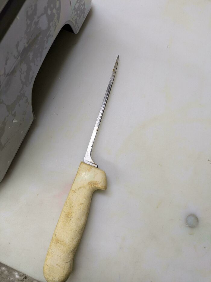 Worn-down knife with a yellowed handle, illustrating the effects of time.