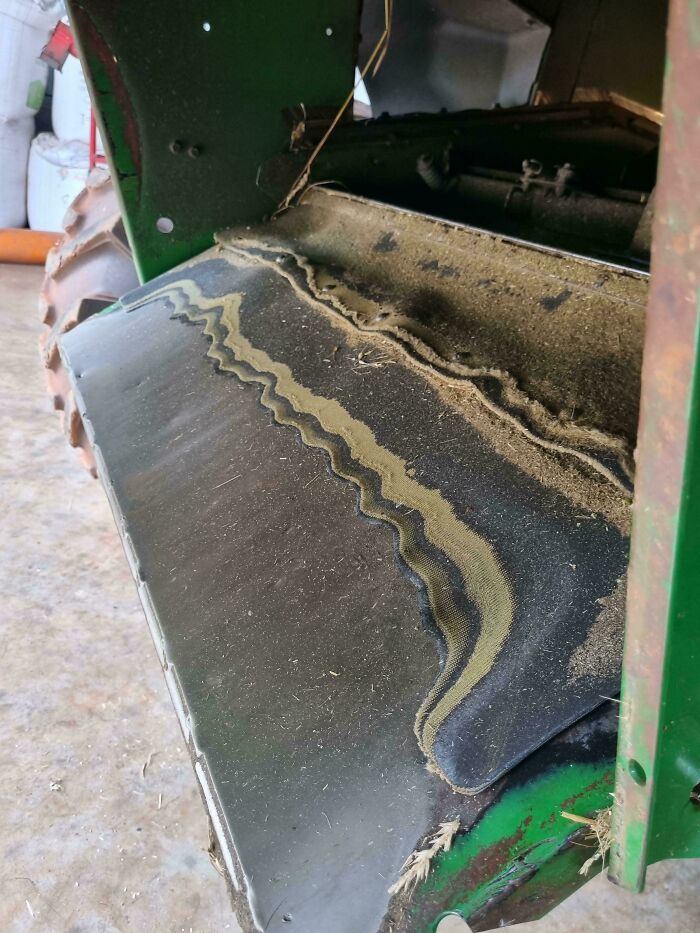 Worn-down conveyor belt in a machine, illustrating how time works on materials.