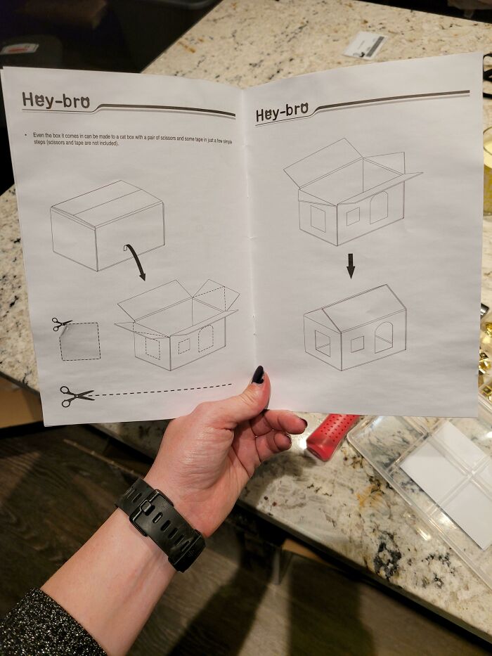 Instructions for assembling a box from a surprising product, held by a person with a black watch.