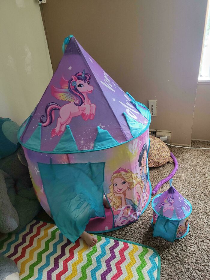 Colorful unicorn-themed play tent for kids, featuring princesses and a small matching backpack, on a vibrant rug.