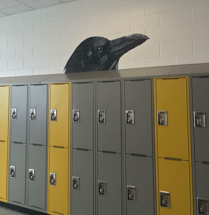 Crow mural seemingly emerging from the top of mismatched yellow and gray lockers represents unfortunate interior design.