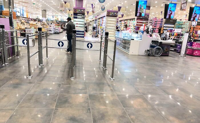 Crowded store interior showing unfortunate public interior design with misplaced wheelchair ramp.