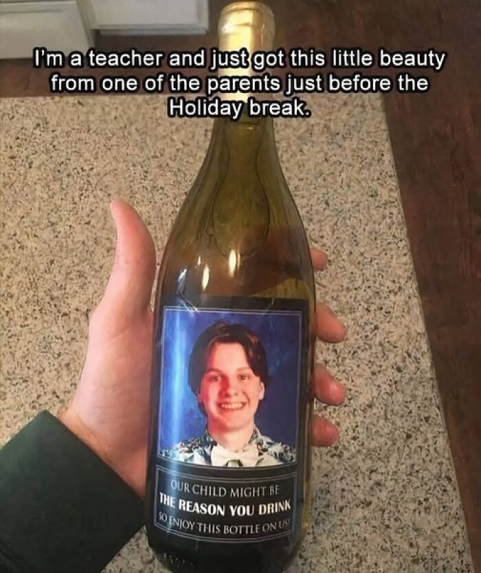 A wine bottle with a humorous science meme label featuring a child's photo and a playful message to a teacher.