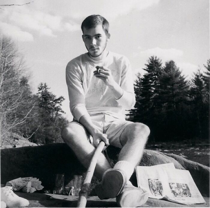 A person outdoors holding a stick, with papers nearby, exemplifying historical inventions ahead of their time.