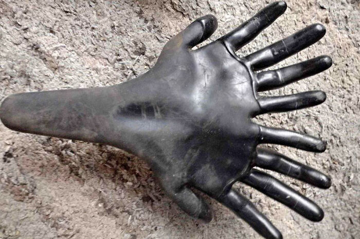 Unusual black glove with multiple fingers, a creepy thing to sell online.