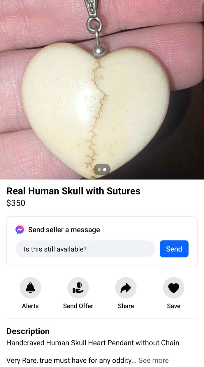 Heart pendant made from real human skull with sutures, displayed on a hand for online sale.