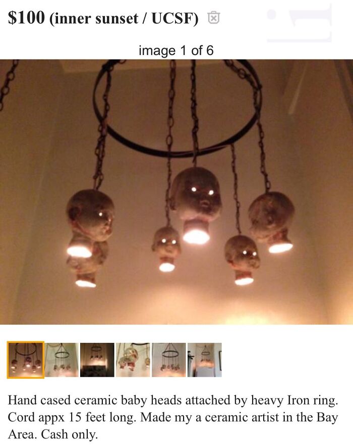 Ceramic baby head chandelier, eerie decor sold online, featuring iron ring and lights.