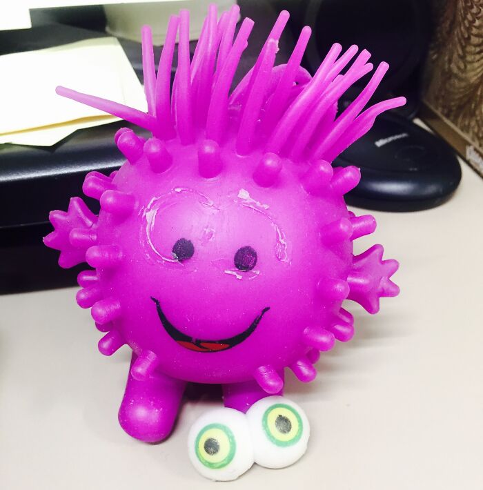 Purple spiky toy with detachable eyes on a desk, showcasing cool products with surprises.