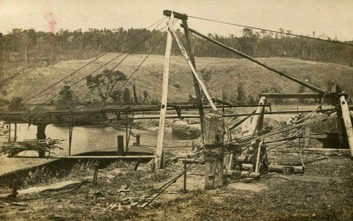 Historical invention by a river, displaying early engineering ingenuity amidst a natural landscape.