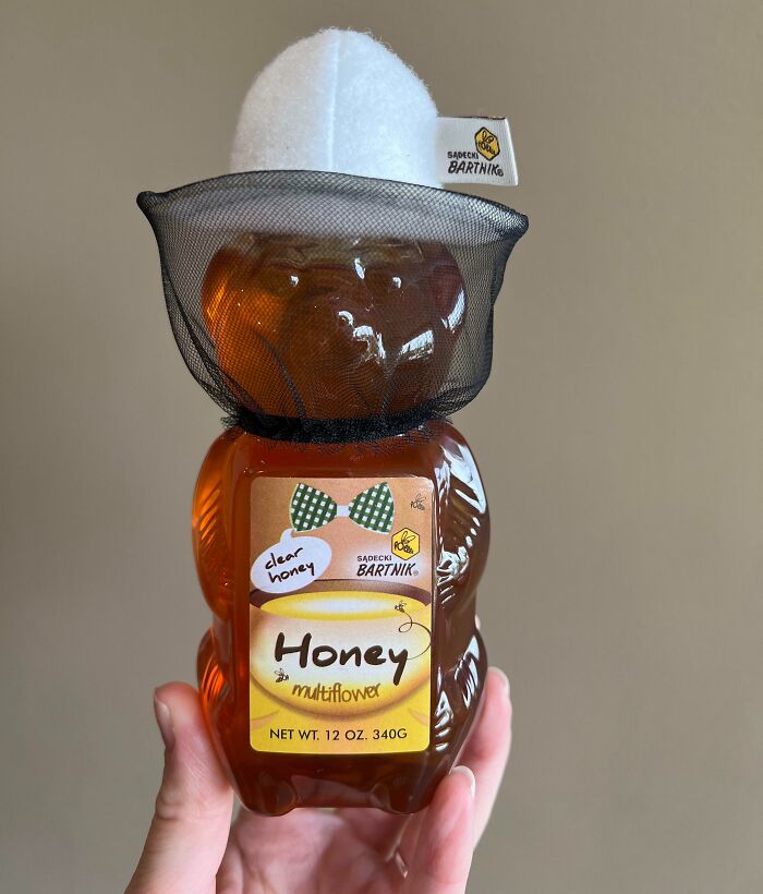 Honey bear bottle with a netted hat, showcasing cool product surprises.