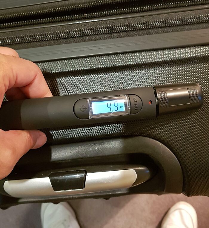 Digital luggage scale with LED display showing weight, an unexpected cool product.