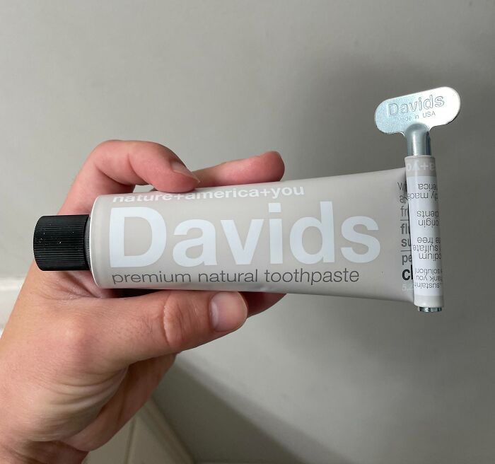 Tube of Davids toothpaste with a metal squeezer, showcasing a cool product with surprises.