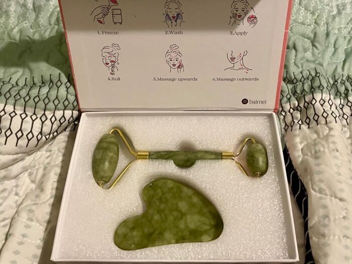 Green jade roller set with instructions, popular on TikTok for beauty routines.