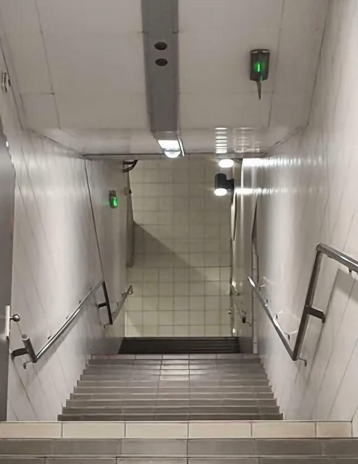 Confusing perspectives of stairwell creating optical illusion with ceiling appearing as floor.