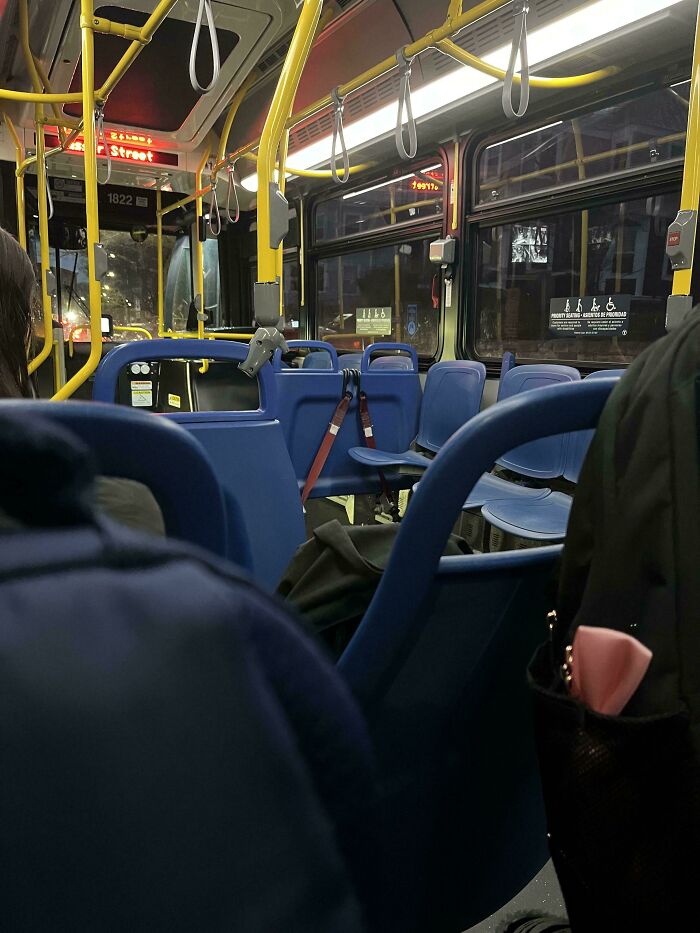 Bus seat crowded with bags, making it difficult for others to sit, showcasing inconsiderate behavior.