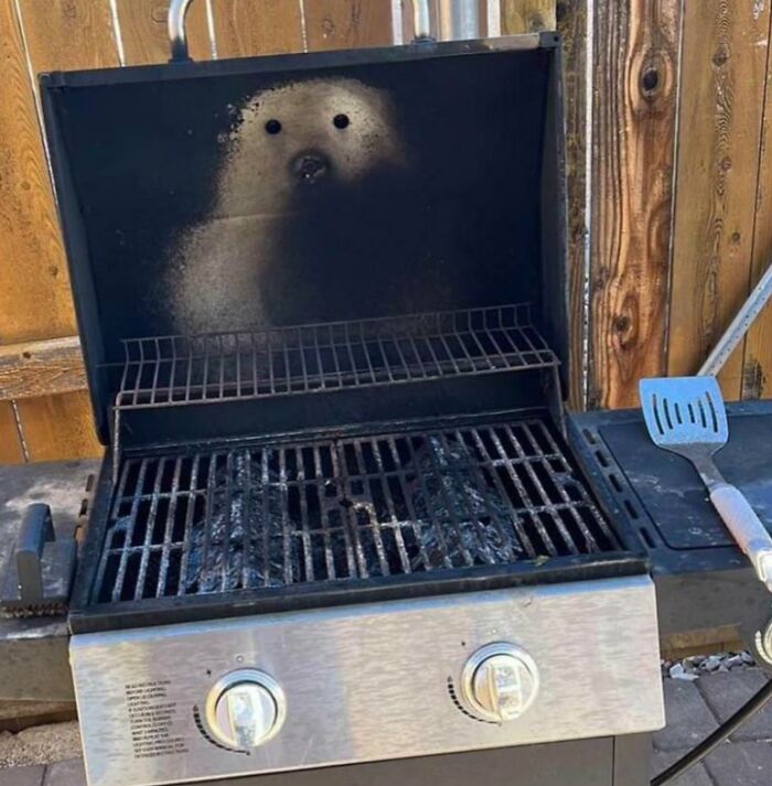 Grill with soot pattern creating a face, a classic example of pareidolia.