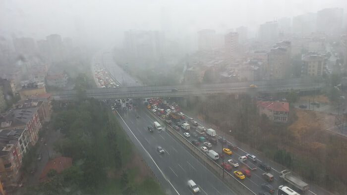 Traffic jam on a rainy day, showcasing people being complete jerks by blocking lanes on a busy highway.