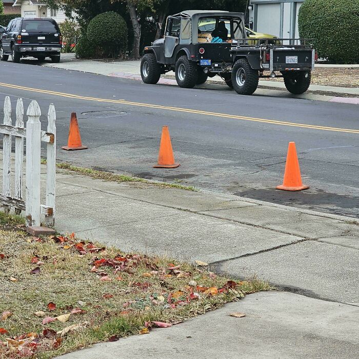 A truck blocking driveway marked by cones, exemplifying people being jerks.