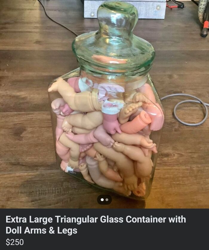 Glass jar filled with disassembled doll parts, a creepy item for sale online.